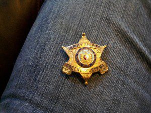 GOLD DEPUTY SHERIFF BADGE.